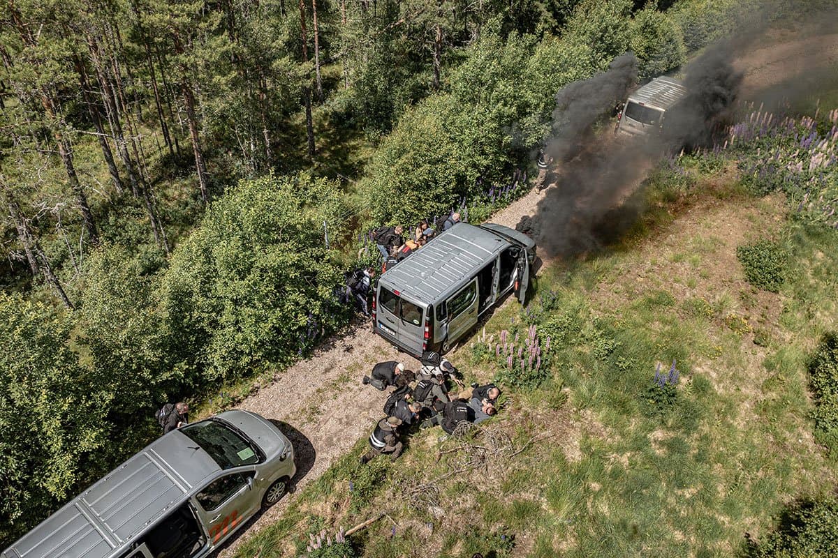 Aerial view of a medical rescue during a vehicle incident on a forest road