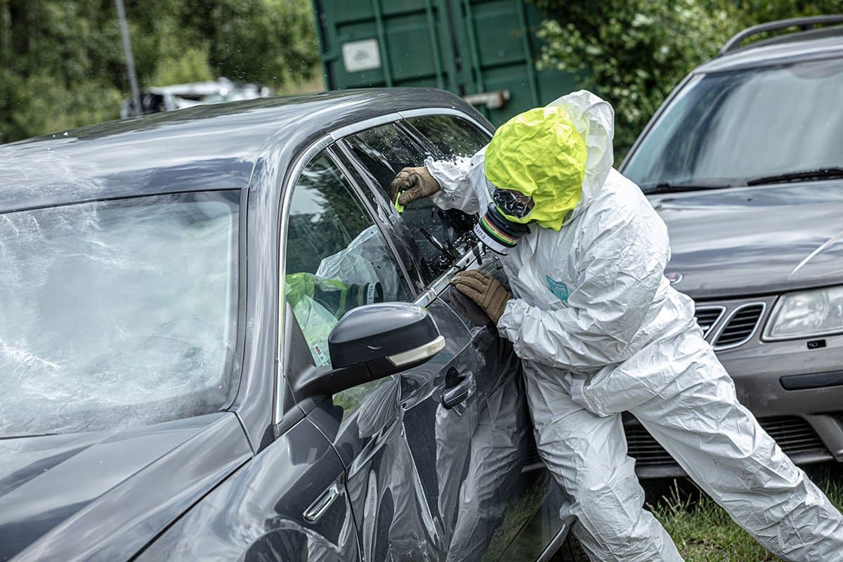 Responder in protective gear at a vehicle